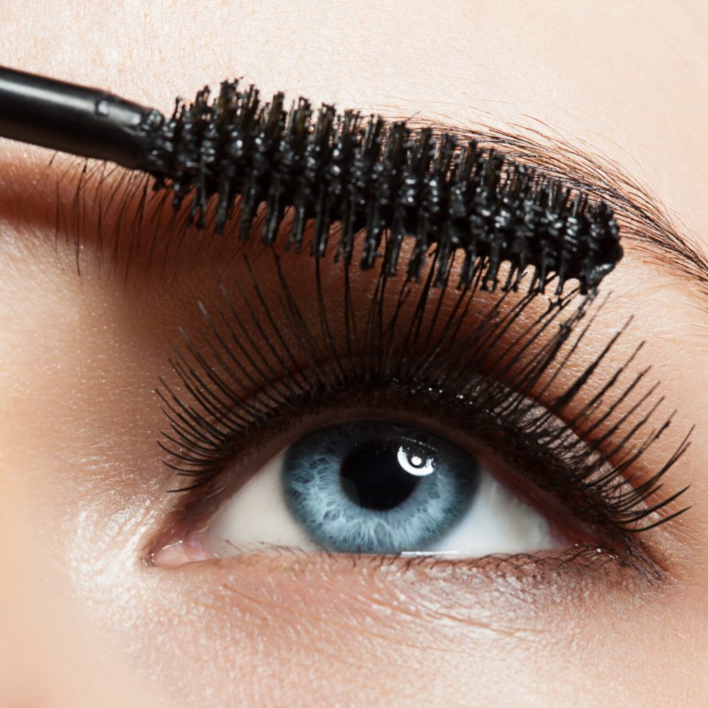 Close-up of blue eye with long lashes with mascara Close-up of make-up blue eye with long lashes with black mascara