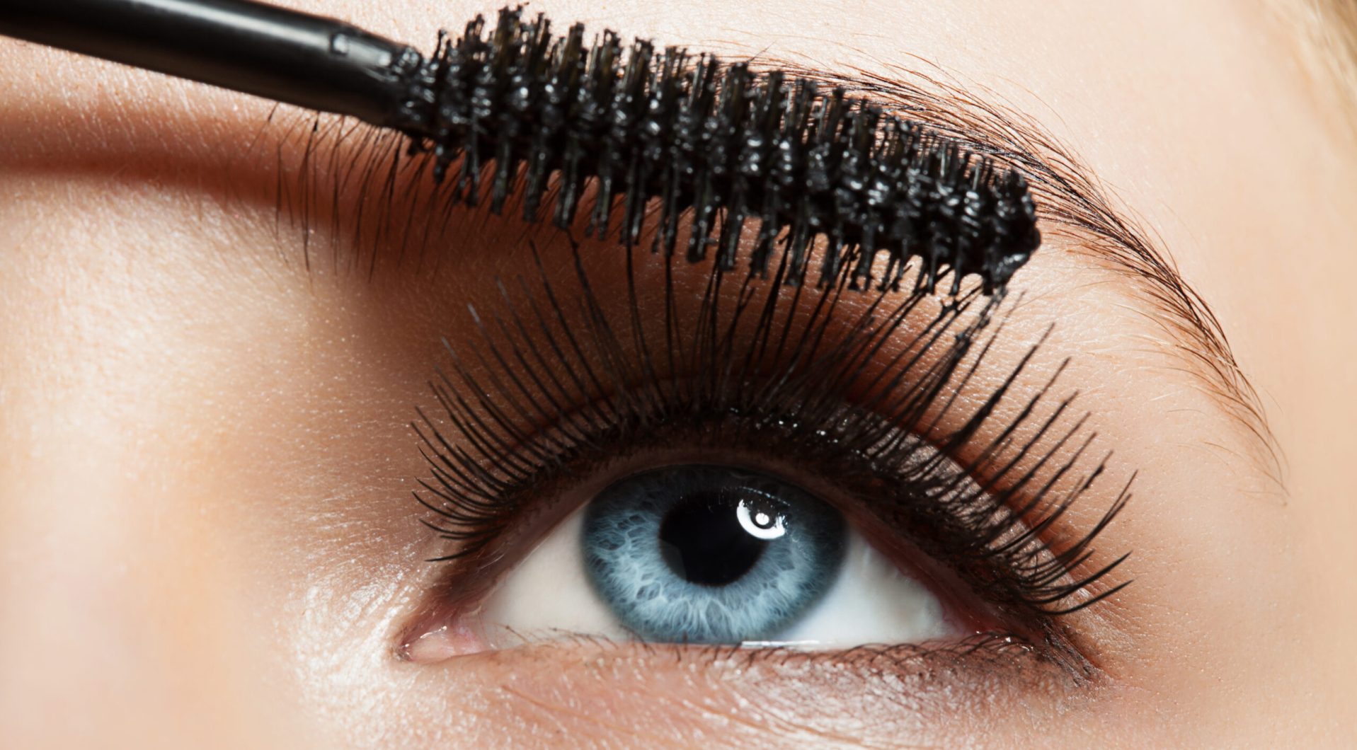 Close-up of make-up blue eye with long lashes with black mascara